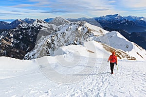 The mountaineer walking on the top of the ridge