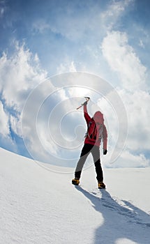 Mountaineer walking uphill along a snowy slope