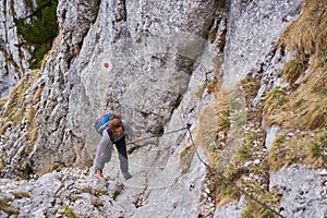 Mountaineer woman climbing in the mountains