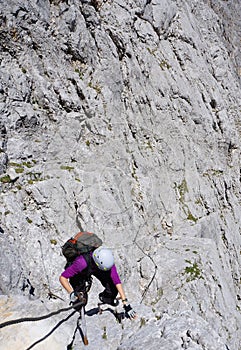 Mountaineer woman climbing on a rocky face