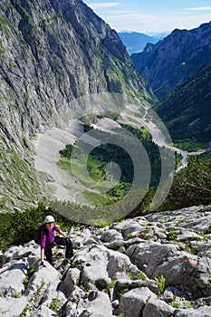 Mountaineer woman climbing on a rocky face