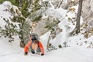 Mountaineer woman descending a gully