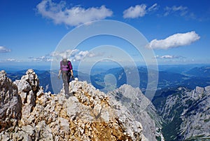 Mountaineer woman on top of a mountain