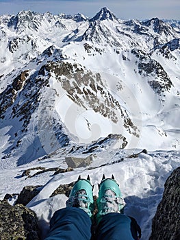 Mountaineering with crampons on ski boots. Ski tour on the fluela wisshorn in davos. Steep summit ascent. Swiss Alps