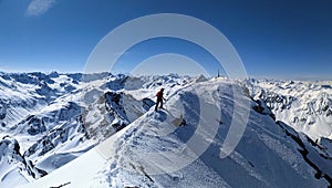 Mountaineering with crampons on ski boots. Ski tour on the fluela wisshorn in davos. Steep summit ascent. Swiss Alps