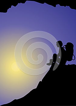 Mountaineering. Sitting on the top of the world. Silhouette of a active man