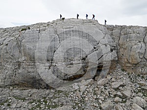 The mountaineers, accompanied by their proficient staff, fearlessly embarked on a journey of conquering high cliffs, their