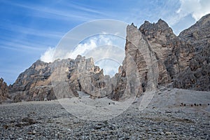 Mountaineers descend from Fontananegra pass in a wonderful rocky scenario