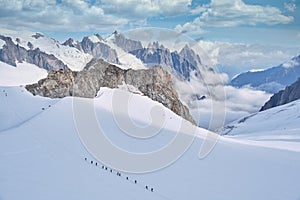 Mountaineers roped together to ascend a glacier