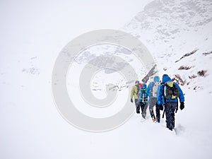 Mountaineers team walks in fresh snow during a winter expedition