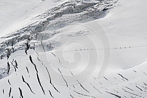 Mountaineers walking on the Geant Glacier, in the Mont Blanc massif, highest mountain range in the Alps