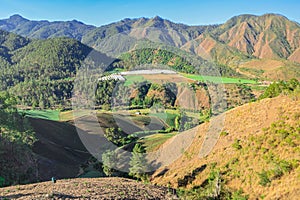 Mountainous agricultural landscape, sloped fields, terraced plantings photo