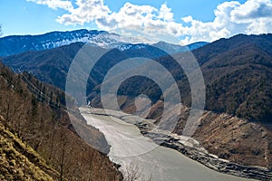 A mountainous landscape with a large dewatered mountain river