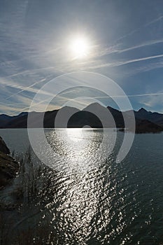 Mountainous Landscape with Sun and Reflection of Light Water Mas