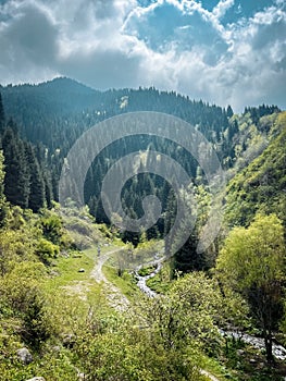 Mountainous landscape with a winding road through the valley photo