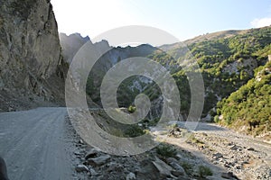 Mountainous road leading to Lahic village in Ismayilli region of Azerbaijan, with car