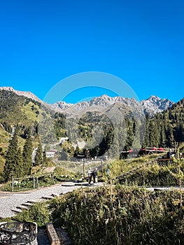 Mountainous terrain with trees and a building photo