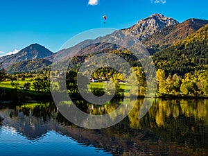 Mountains in autumn colors reflecting the lake