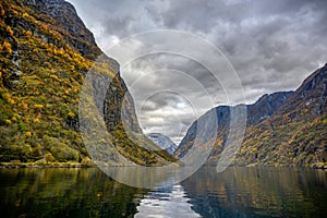 Mountains in the autumn season that reflect the water at Flam in Norway