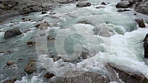 Mountains blue bubbling cold water river and rocks