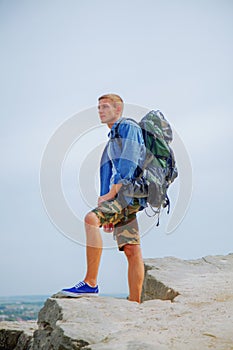 Mountains are calling and I must go. Male traveler with backpack trekking in mountains. Mountain is the best place to find