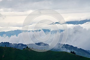 The mountains cloudily in Valley grassland photo