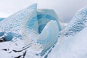 Mountains with clouds on Antarctica. Glaciers, icebergs and ice caves of Southern hemisphere. Global climate change on Earth.