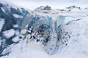 Mountains with clouds on Antarctica. Glaciers, icebergs and ice caves of Southern hemisphere. Global climate change on Earth.