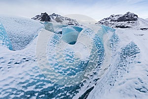 Mountains with clouds on Antarctica. Glaciers, icebergs and ice caves of Southern hemisphere. Global climate change on Earth.