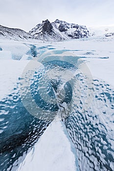 Mountains with clouds on Antarctica. Glaciers, icebergs and ice caves of Southern hemisphere. Global climate change on Earth.