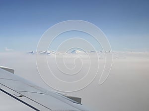 Mountains and clouds out a plane window