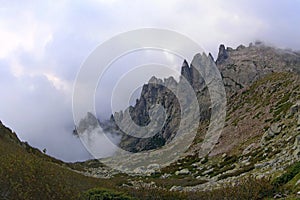 The mountains of Corsica, sharp rocks in the clouds, trekking route GR-20