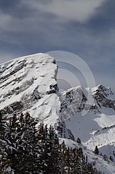 Mountains covered with snow and clouds and trees