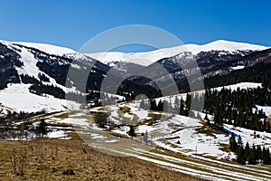 Mountains covered in snow on sunny day. Early spring landscape