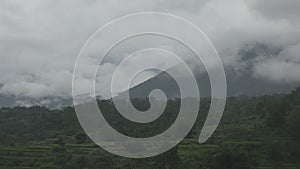 mountains with cumulonimbus clouds and rice terraces on the plain, Bali, Indonesia