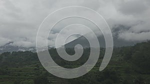 mountains with cumulonimbus clouds and rice terraces on the plain, Bali, Indonesia