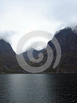 Mountains and Fjords in Norway with Low Clouds