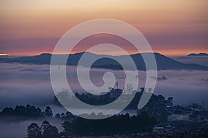 Mountains in fog at beautiful morning in autumn in Dalat city, Vietnam.