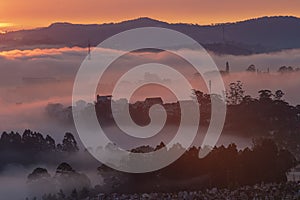 Mountains in fog at beautiful morning in autumn in Dalat city, Vietnam.