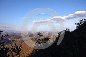 Mountains, forest and blue sky with clouds
