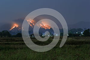 Mountains with forest fires on fire villages and fields, forest fires at night look sad