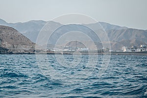 Mountains in front of the water in Playa de los Muertos, Spain