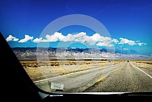 Mountains and highway through a car window