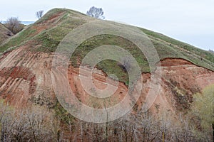 Mountains and hills on the coast of the river Volga. Beautiful patterns of rocks, meadows, green grass and trees. Beautiful spring