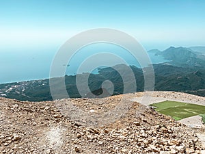 Mountains in a hot, tropical country against a blue sky. green plants grow on the mountains. at the top there is a cover for