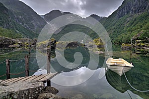 Mountains and lake with a boat in Bondhusdalen, Norway