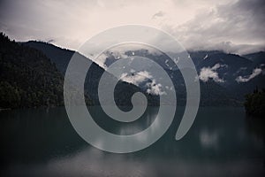 Mountains, lake, clouds, reflection on a rainy day