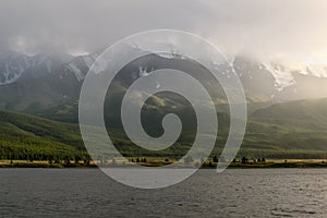 Mountains lake overcast sunlight fog