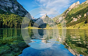 Mountains and lake in the Switzerland. Reflection on the water surface.