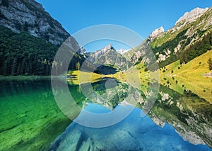 Mountains and lake in the Switzerland. Reflection on the water surface.